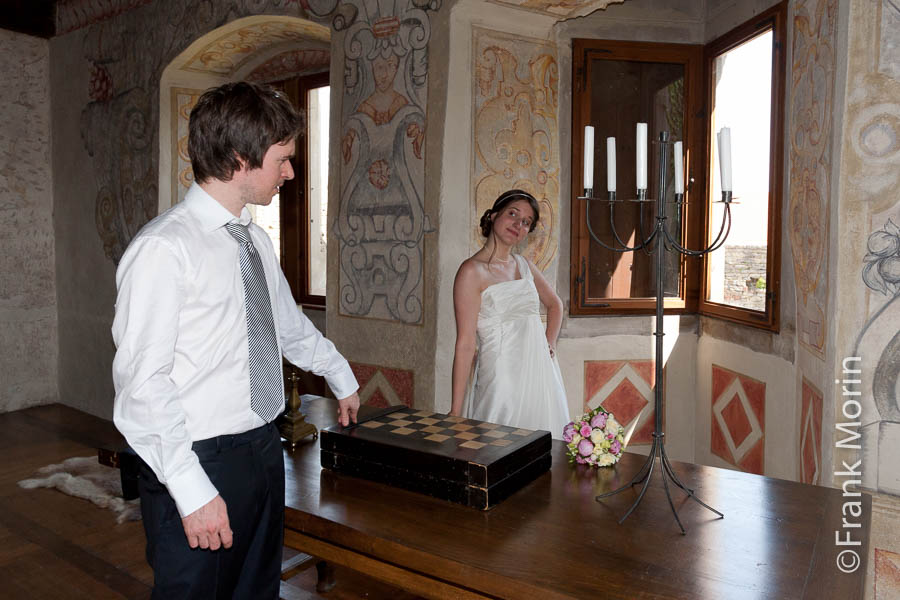Les mariés dans le château, jouent la comédie autour d'une table avec un jeu d'échecs